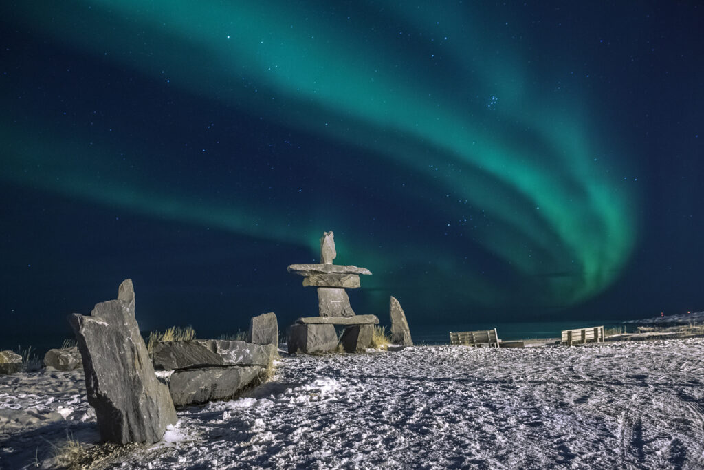 Inukshuk in the northern lights.